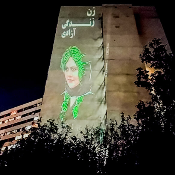 The face of Mahsa (Jina) Amini is projected on the buildings in the Ekbatan neighbourhood of Tehran, accompanied by the slogan "Woman, Life, Freedom." October 25, 2022, anonymous photographer