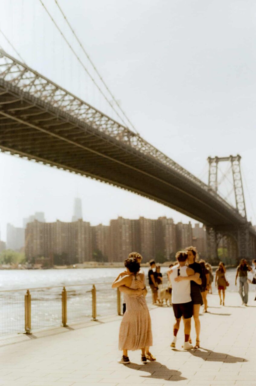 photo of people dancing under a bridge